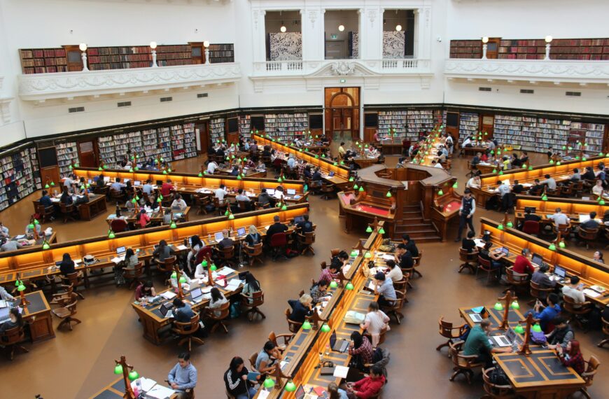 Aerial view of a bustling study hall in a university library with students studying.